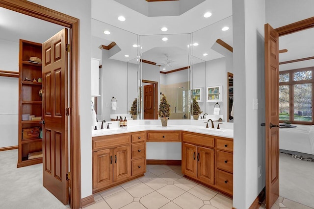full bath featuring double vanity, a ceiling fan, and a sink