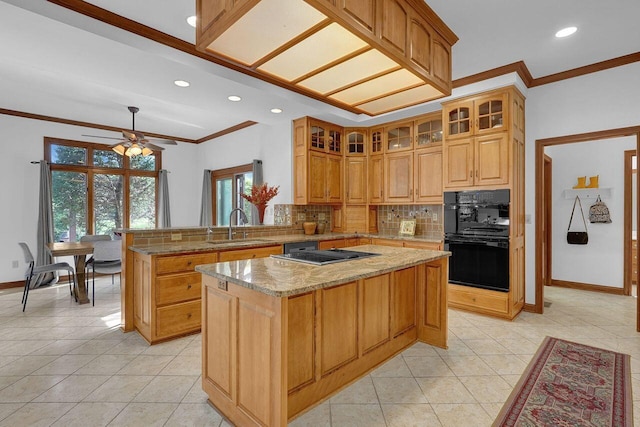 kitchen featuring decorative backsplash, a sink, a center island, baseboards, and stainless steel stovetop