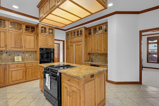 kitchen with light tile patterned floors, black appliances, a center island, and decorative backsplash