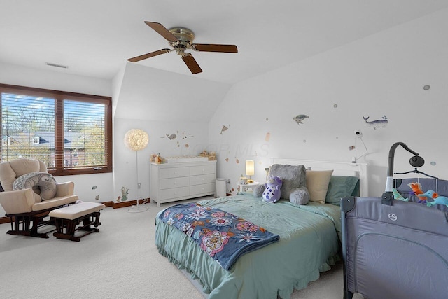 bedroom featuring light colored carpet, visible vents, ceiling fan, baseboards, and vaulted ceiling