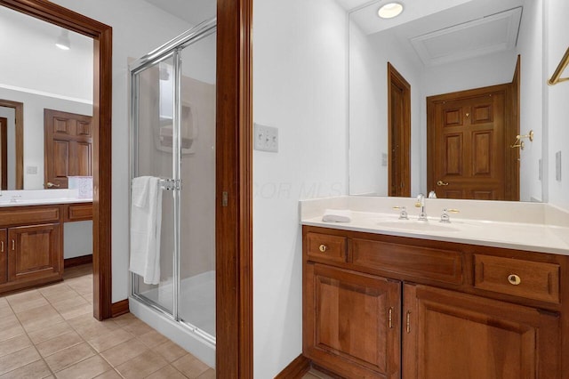 bathroom with baseboards, a shower stall, tile patterned flooring, and vanity
