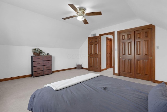 bedroom with lofted ceiling, light colored carpet, visible vents, baseboards, and a ceiling fan