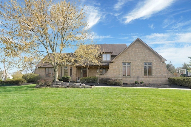 view of front of property with a front yard and brick siding