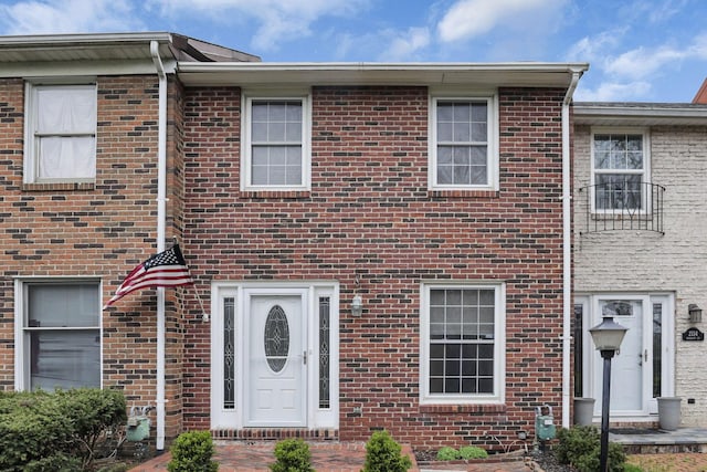 view of property featuring brick siding