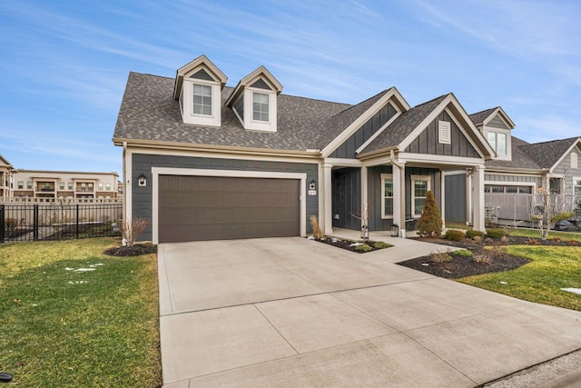 view of front of property with a garage, fence, concrete driveway, and a front yard