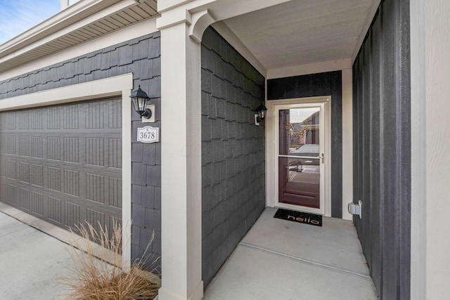 doorway to property with a garage