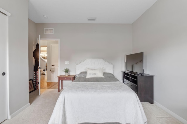 carpeted bedroom with baseboards and visible vents