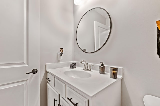 half bathroom featuring toilet and vanity