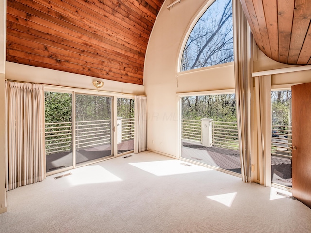 interior space featuring visible vents, plenty of natural light, wood ceiling, carpet floors, and high vaulted ceiling