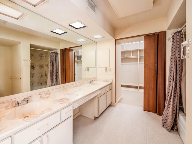 bathroom with a sink, visible vents, double vanity, and a shower with shower curtain