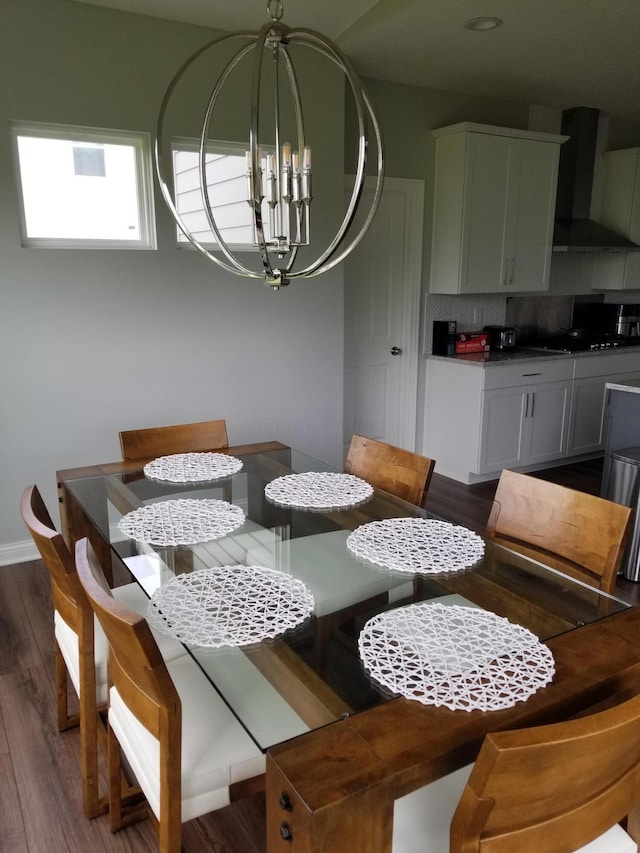 dining room with dark wood finished floors, baseboards, and a chandelier
