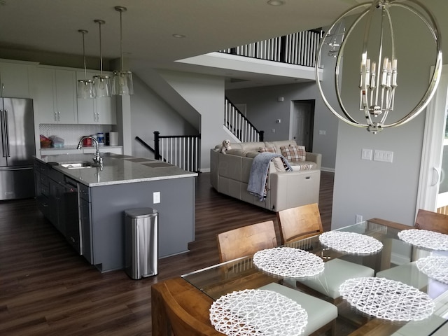 dining space featuring baseboards, dark wood-style flooring, and stairs