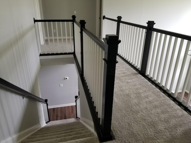 stairs with carpet flooring and baseboards