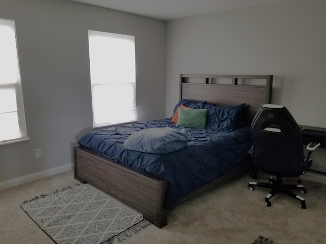 bedroom with baseboards and carpet flooring