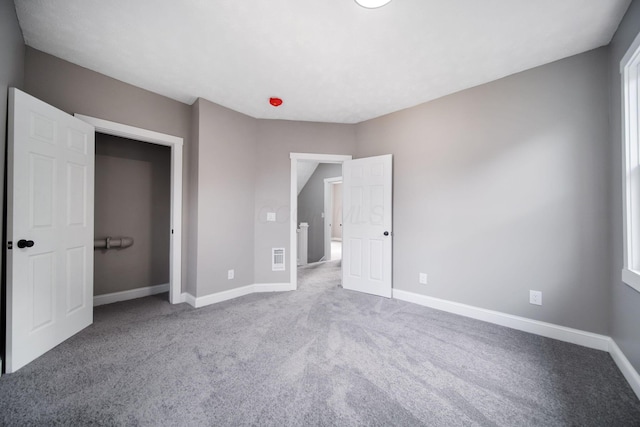 unfurnished bedroom featuring baseboards and carpet floors