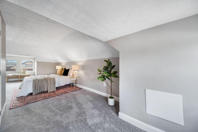 unfurnished bedroom featuring baseboards, lofted ceiling, carpet floors, and a textured ceiling