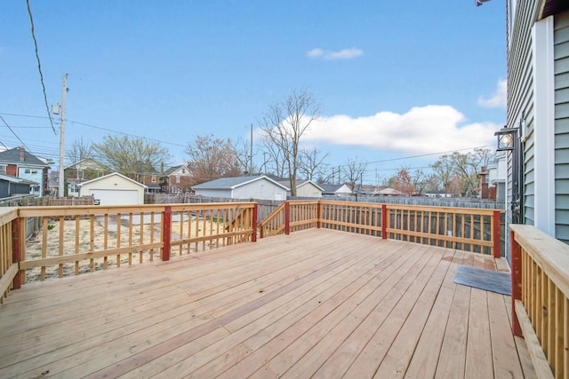 deck featuring fence, a residential view, and an outdoor structure