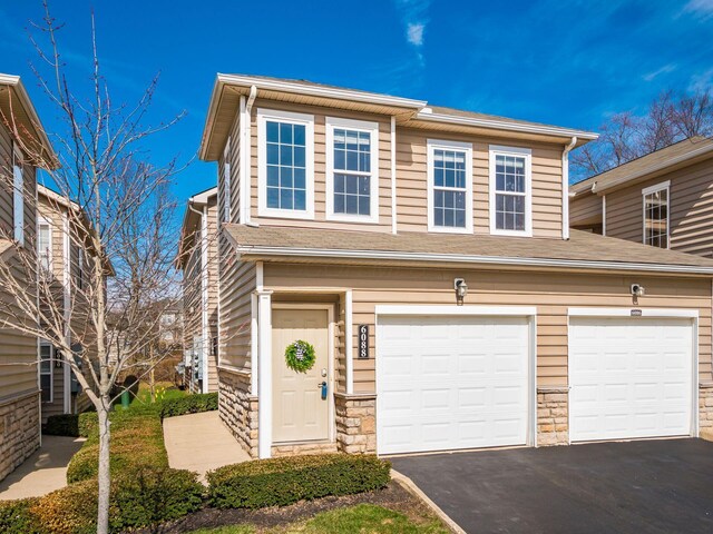 6088 Sowerby Ln, Westerville, OH 43081 - view of front of house featuring stone siding, aphalt driveway, and a garage