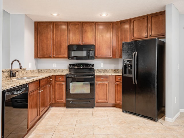 6088 Sowerby Ln, Westerville, OH 43081 - kitchen featuring a sink, light stone countertops, black appliances, and brown cabinets