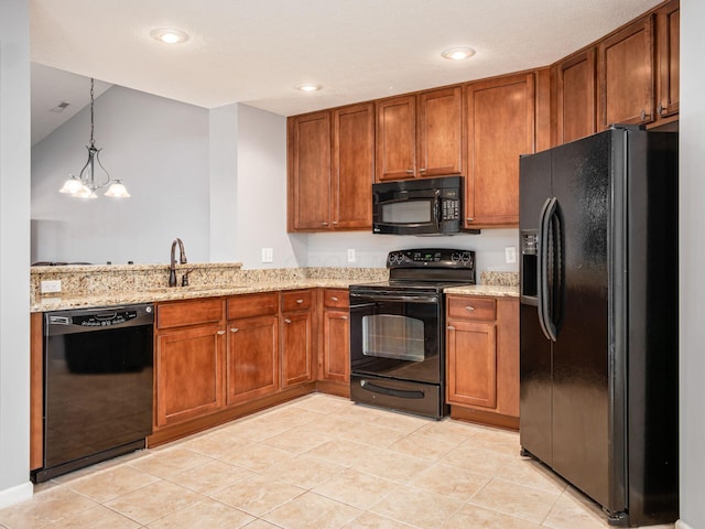 6088 Sowerby Ln, Westerville, OH 43081 - kitchen featuring hanging light fixtures, a sink, light stone countertops, black appliances, and brown cabinets