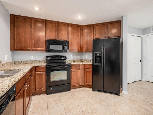 6088 Sowerby Ln, Westerville, OH 43081 - kitchen featuring a sink, light stone countertops, black appliances, and brown cabinetry