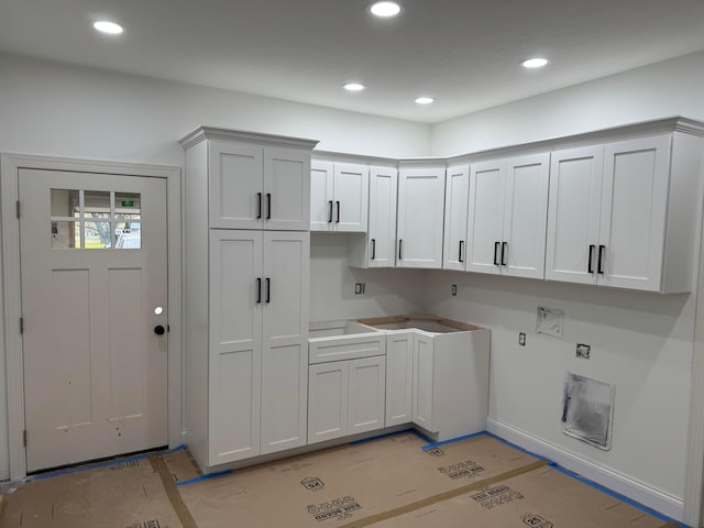 washroom with cabinet space, recessed lighting, and hookup for a washing machine