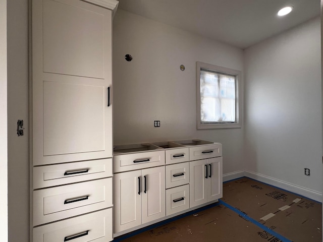 kitchen with recessed lighting, white cabinetry, and baseboards