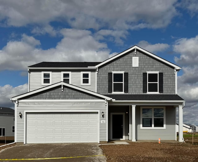traditional home featuring a porch and driveway