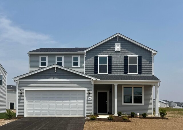 280 Dowler Dr Lot 349, South Bloomfield, OH 43103 - view of front of home featuring asphalt driveway, covered porch, and a garage