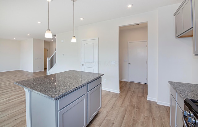 280 Dowler Dr Lot 349, South Bloomfield, OH 43103 - kitchen featuring gray cabinets, light wood finished floors, dark stone counters, stainless steel stove, and recessed lighting