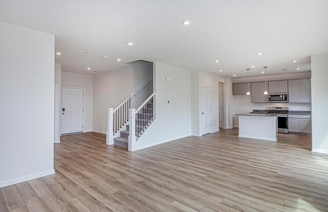 280 Dowler Dr Lot 349, South Bloomfield, OH 43103 - unfurnished living room with stairs, light wood-type flooring, and recessed lighting