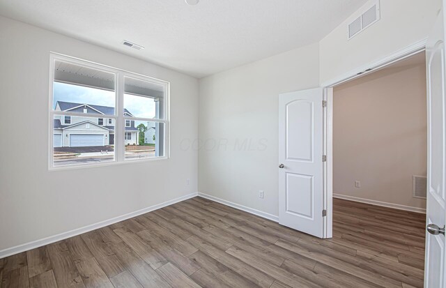 280 Dowler Dr Lot 349, South Bloomfield, OH 43103 - unfurnished bedroom with wood finished floors and baseboards