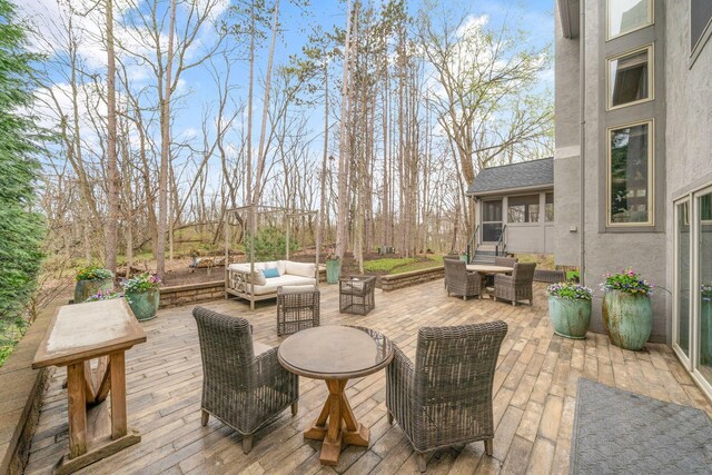 wooden terrace featuring outdoor lounge area
