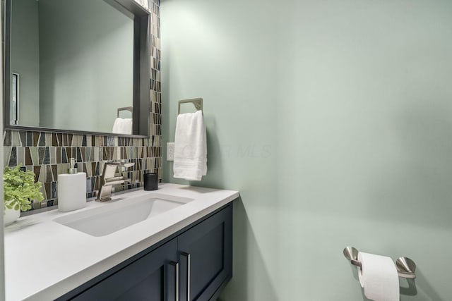 bathroom featuring decorative backsplash and vanity
