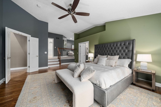 bedroom with baseboards, wood finished floors, vaulted ceiling, and a ceiling fan