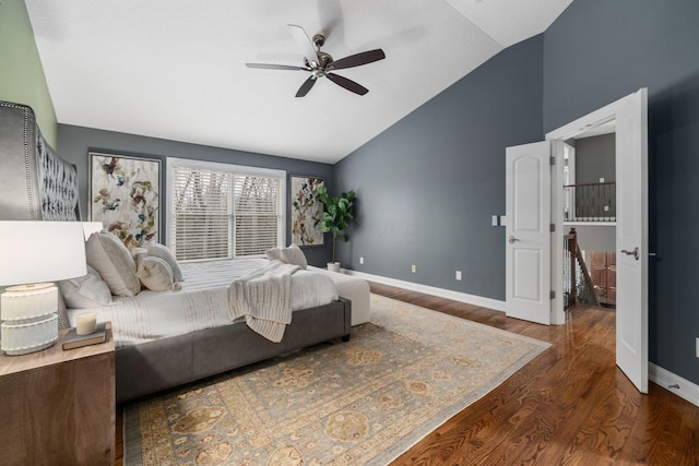 bedroom featuring wood finished floors, ceiling fan, baseboards, and lofted ceiling