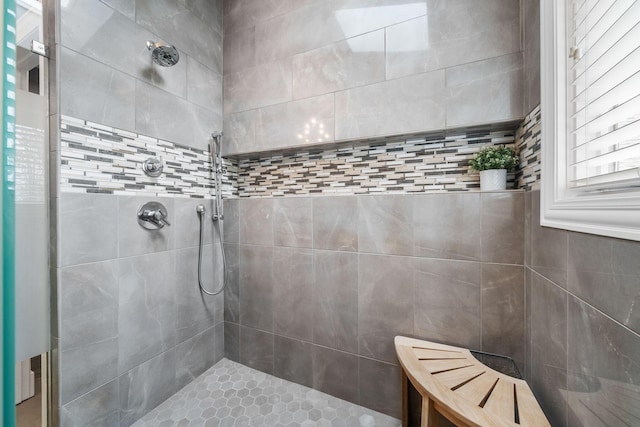 full bath with a tile shower