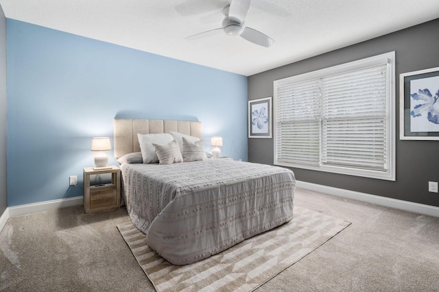 bedroom with ceiling fan, baseboards, and carpet floors