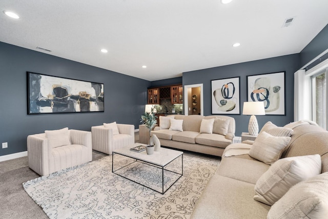 living room featuring visible vents, baseboards, carpet, and recessed lighting