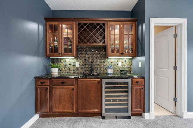 bar with indoor wet bar, wine cooler, decorative backsplash, light colored carpet, and a sink