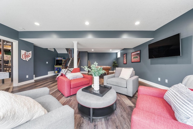 living area featuring wood finished floors, baseboards, stairs, and recessed lighting