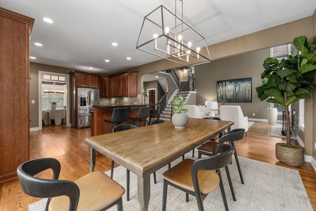 dining area with recessed lighting, stairway, light wood-type flooring, and baseboards