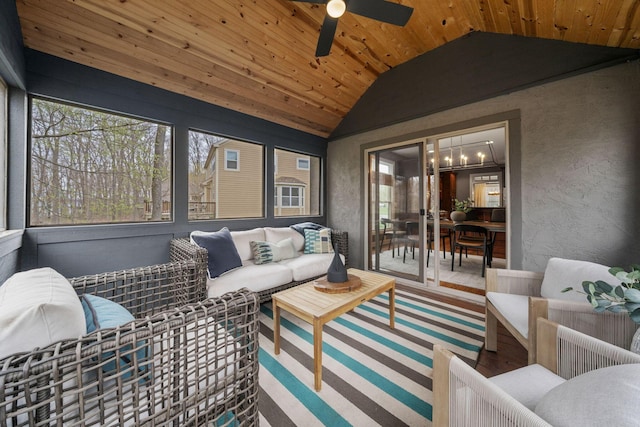 sunroom / solarium featuring an outdoor living space and ceiling fan with notable chandelier