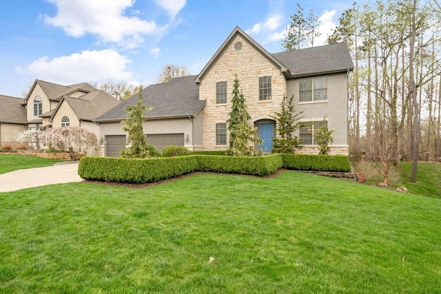 view of front of home with a front lawn, stone siding, and stucco siding
