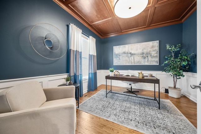 office featuring ornamental molding, a wainscoted wall, coffered ceiling, wooden ceiling, and wood finished floors