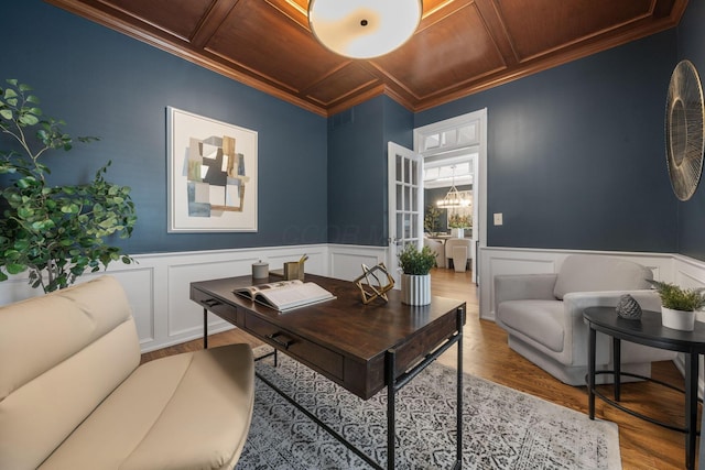 office featuring coffered ceiling, crown molding, wood finished floors, and visible vents