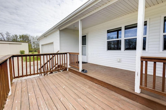 wooden deck featuring a garage