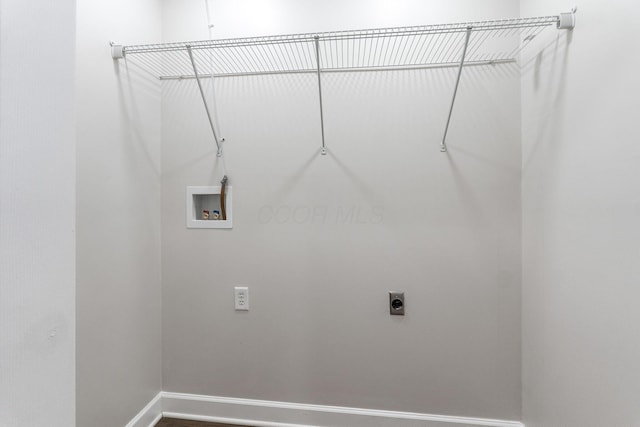 laundry room featuring hookup for a washing machine, laundry area, baseboards, and electric dryer hookup