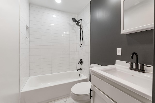bathroom featuring marble finish floor, bathtub / shower combination, toilet, and vanity