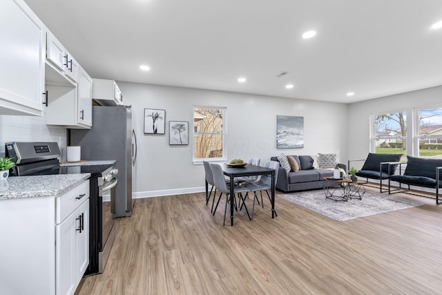 kitchen with light wood finished floors, white cabinetry, tasteful backsplash, stainless steel electric stove, and recessed lighting